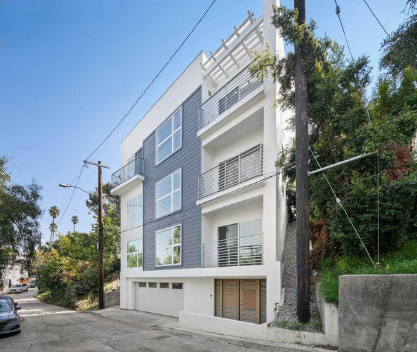 Side view of a blue and white multi-story home