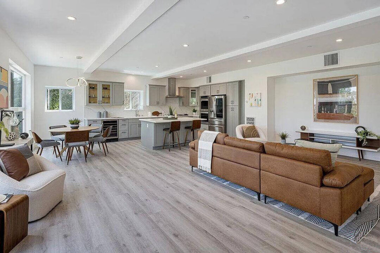 Living room with a kitchen and brown couch