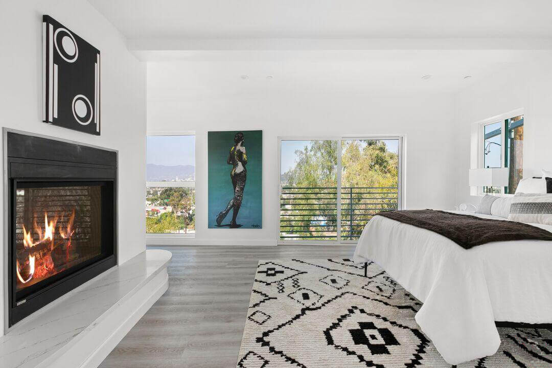 Bedroom with a fireplace and open windows